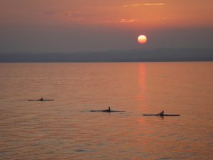 sunset photo with canoes on a lake