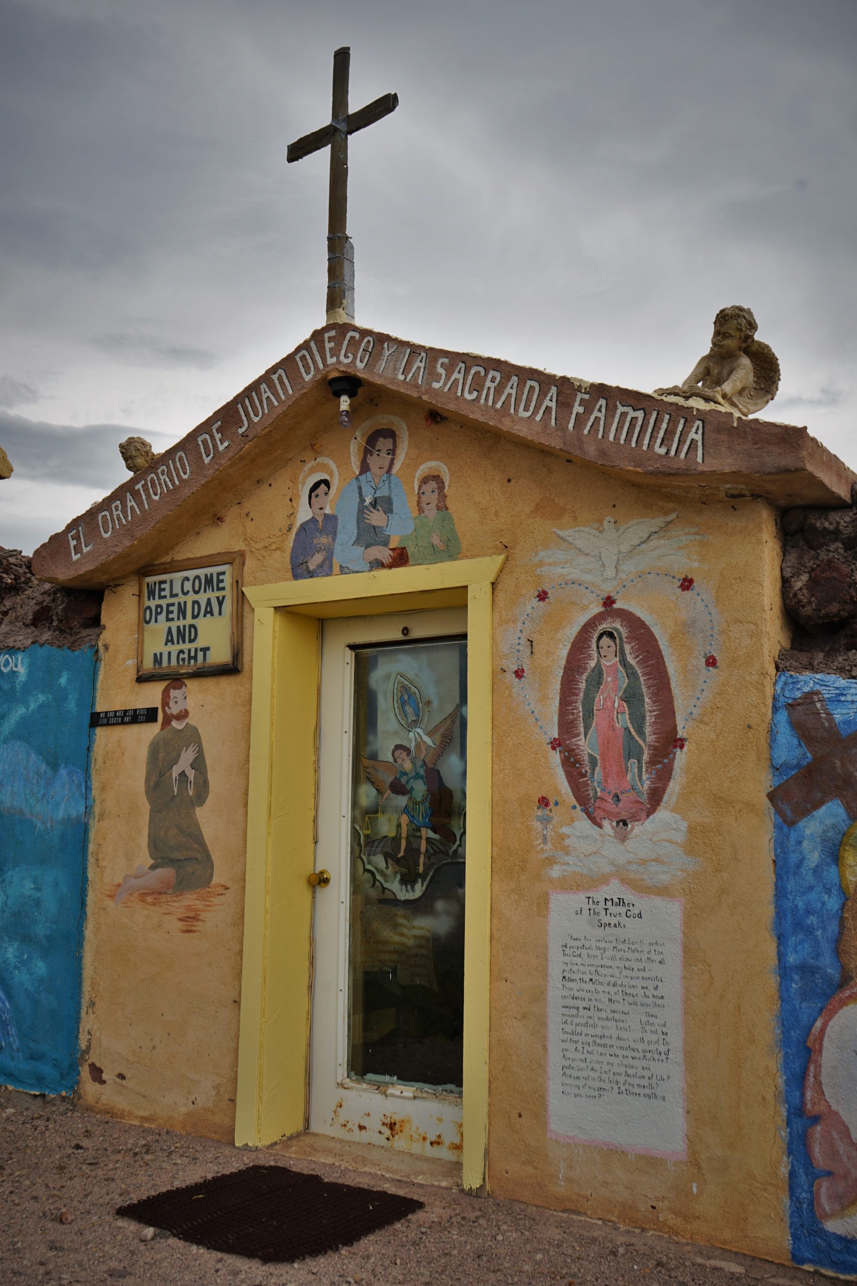 small painted chapel front with cross on top 