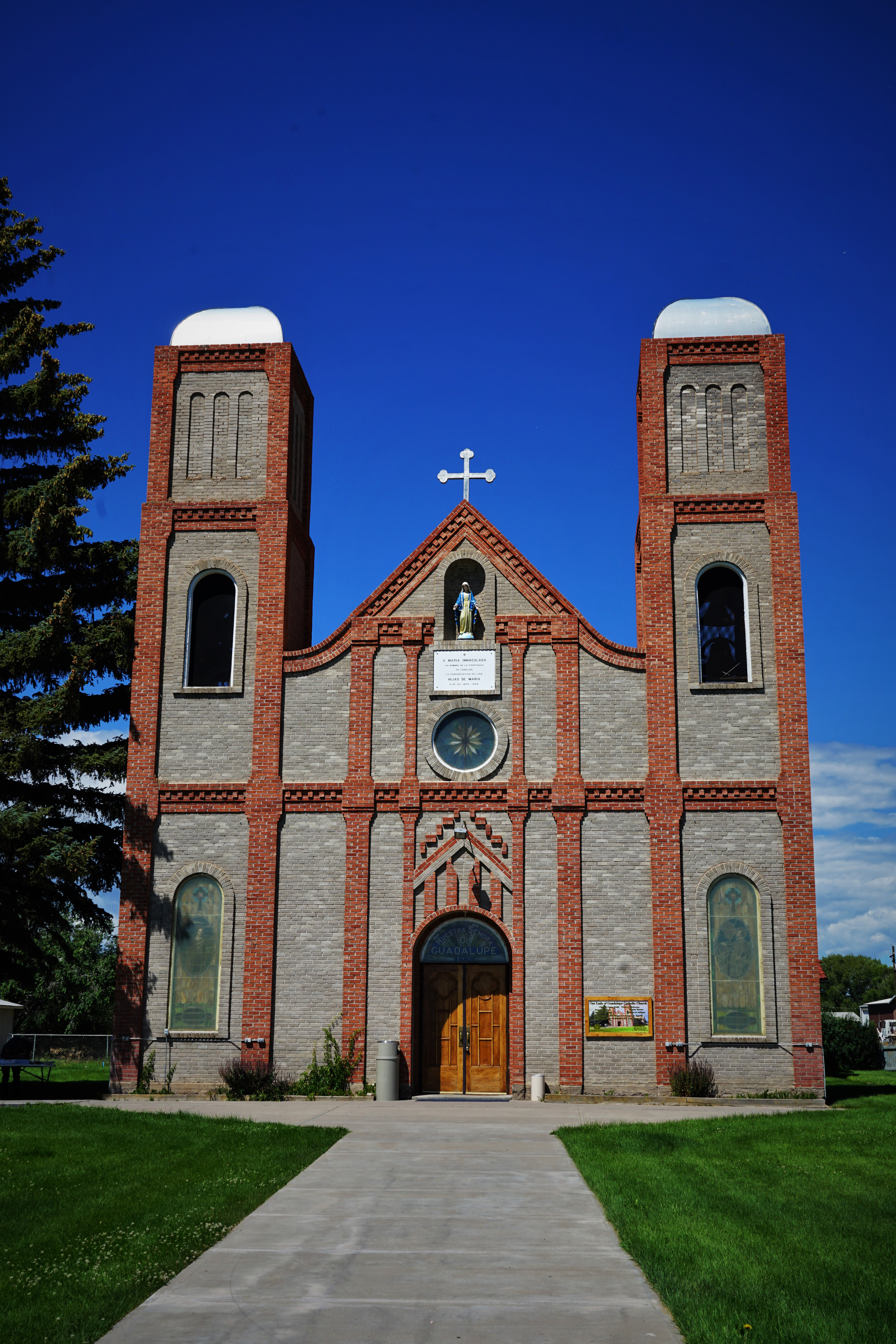 Catholic church with red brick in a Southwestern style