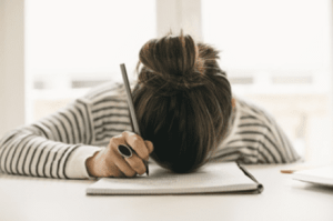 writers block head down on notebook